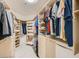 Spacious walk-in closet with custom shelving and ample storage space for clothes and accessories at 9718 Camino Capistrano Ln, Las Vegas, NV 89147