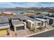 Community aerial view of lakefront modern homes with desert landscaping at 104 Tre Pietre St, Henderson, NV 89011
