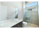 Contemporary bathroom with tile flooring, glass shower, quartz countertop, and brushed nickel fixtures at 104 Tre Pietre St, Henderson, NV 89011
