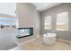 View of bathroom with a soaking tub, fireplace, and view of the exterior at 104 Tre Pietre St, Henderson, NV 89011