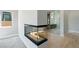View of a double sided fireplace between the bedroom and glass enclosed shower and tub at 104 Tre Pietre St, Henderson, NV 89011