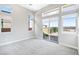 Bright bedroom with multiple windows, light gray carpet, and access to a patio at 104 Tre Pietre St, Henderson, NV 89011