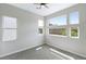 Bright bedroom featuring multiple windows offering plentiful natural light and neutral color scheme at 104 Tre Pietre St, Henderson, NV 89011