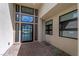 Modern home entryway featuring a glass front door, sidelights, and a beautiful lake view at 104 Tre Pietre St, Henderson, NV 89011