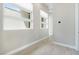 Hallway featuring neutral paint, clean white trim and contemporary tile floors at 104 Tre Pietre St, Henderson, NV 89011