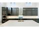 Modern kitchen features gray cabinets, stainless steel appliances, and a large island at 104 Tre Pietre St, Henderson, NV 89011
