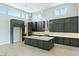 Contemporary kitchen features modern appliances, gray cabinets, and a large center island with bar seating at 104 Tre Pietre St, Henderson, NV 89011