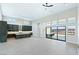 Spacious living room with tall ceilings, large windows with lake views, and a modern kitchen at 104 Tre Pietre St, Henderson, NV 89011