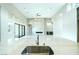 Bright, open living room with high ceilings, stone fireplace and sliding doors to outdoor space at 104 Tre Pietre St, Henderson, NV 89011