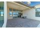 Covered patio showcasing outdoor seating, pavers and views of the mountains in the distance at 104 Tre Pietre St, Henderson, NV 89011