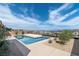 Backyard featuring a modern pool design with desert landscaping and distant lake views at 104 Tre Pietre St, Henderson, NV 89011