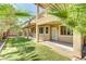 Home backyard featuring a covered patio and a manicured lawn at 11478 Bargetto Ct, Las Vegas, NV 89141
