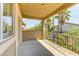 Balcony with wrought iron railing overlooking neighborhood with palm trees and lush foliage at 11478 Bargetto Ct, Las Vegas, NV 89141