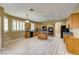 Open kitchen features an island, wood cabinets, granite countertops, and stainless steel appliances at 11478 Bargetto Ct, Las Vegas, NV 89141