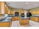 Spacious kitchen featuring light wood cabinets, granite countertops, and an island at 11478 Bargetto Ct, Las Vegas, NV 89141