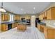 Well-equipped kitchen with wood cabinets, a central island, and lots of storage at 11478 Bargetto Ct, Las Vegas, NV 89141