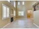 Living room with tall windows, a fireplace, and wood flooring at 11478 Bargetto Ct, Las Vegas, NV 89141