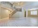 Open floor plan featuring wood floors, a staircase with decorative ironwork, and a chandelier at 11478 Bargetto Ct, Las Vegas, NV 89141