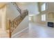 Spacious living room with lots of light, a fireplace, and staircase with decorative ironwork at 11478 Bargetto Ct, Las Vegas, NV 89141
