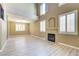 Bright living room with tall windows, a fireplace, and wood flooring at 11478 Bargetto Ct, Las Vegas, NV 89141