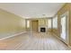 Bright living room with fireplace, wood floors, and large windows with plantation shutters at 11478 Bargetto Ct, Las Vegas, NV 89141