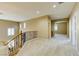 An open, carpeted loft area with decorative railing and natural light at 11478 Bargetto Ct, Las Vegas, NV 89141