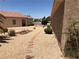 This backyard features desert landscaping and pavers leading to a small garden space at 1396 Couperin Dr, Henderson, NV 89052