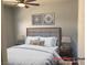 Beautifully staged bedroom with soft lighting, framed art and plush bedding at 1396 Couperin Dr, Henderson, NV 89052
