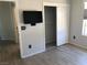 This bedroom features a wall-mounted TV, wood-look flooring and a closet with sliding doors at 1396 Couperin Dr, Henderson, NV 89052