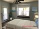 Comfortable bedroom with a ceiling fan and bonus seating area in front of a window at 1396 Couperin Dr, Henderson, NV 89052