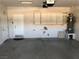 This spacious two-car garage features overhead lighting, white cabinetry, and a water heater at 1396 Couperin Dr, Henderson, NV 89052