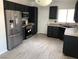 Modern kitchen with stainless steel appliances and stylish black cabinetry at 1396 Couperin Dr, Henderson, NV 89052