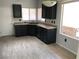 Kitchen featuring dark cabinets, stainless steel appliances, and natural light at 1396 Couperin Dr, Henderson, NV 89052