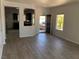 Bright, open-concept living room showcasing wood-look tile and easy kitchen access at 1396 Couperin Dr, Henderson, NV 89052