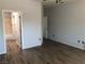 Spacious main bedroom with wood-look tile floors and ensuite bathroom access at 1396 Couperin Dr, Henderson, NV 89052