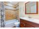 Renovated bathroom with shower and tub combo, modern vanity, and decorative shelves at 1470 Elizabeth Ave # 1, Las Vegas, NV 89119