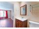 Cozy bathroom featuring a wood vanity, glass shelving, and neutral wall color at 1470 Elizabeth Ave # 1, Las Vegas, NV 89119