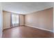 This bedroom features hardwood floors, neutral paint, and a window for natural light at 1470 Elizabeth Ave # 1, Las Vegas, NV 89119