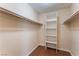 A walk-in closet featuring built-in shelving and a wood rod for clothing storage at 1470 Elizabeth Ave # 1, Las Vegas, NV 89119