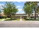 Charming home showcasing its well-maintained lawn and inviting facade nestled between mature trees at 1470 Elizabeth Ave # 1, Las Vegas, NV 89119