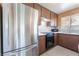 A kitchen featuring mosaic backsplash, stainless steel appliances, and lots of cabinet space at 1470 Elizabeth Ave # 1, Las Vegas, NV 89119