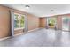 Bright living room featuring neutral colored walls, tile floors and multiple windows with natural light at 1470 Elizabeth Ave # 1, Las Vegas, NV 89119