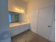 A bright bathroom with tile flooring and a white vanity at 1501 Wintergreen Dr, Las Vegas, NV 89128