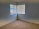 Bright bedroom featuring neutral carpet, natural light, and minimalist style at 1501 Wintergreen Dr, Las Vegas, NV 89128