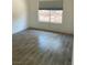Bright bedroom with tile flooring, white walls, and a window overlooking the exterior at 1501 Wintergreen Dr, Las Vegas, NV 89128