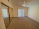 An empty bedroom with ample natural light, neutral carpet and a ceiling fan at 1501 Wintergreen Dr, Las Vegas, NV 89128