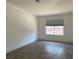 Well-lit bedroom featuring tile flooring, clean white walls, and a large window at 1501 Wintergreen Dr, Las Vegas, NV 89128