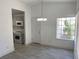 Dining area with window view next to a kitchen, featuring gray cabinets and stainless steel appliances at 1501 Wintergreen Dr, Las Vegas, NV 89128