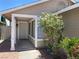 Welcoming front entrance with a storm door and flowering bush at 1501 Wintergreen Dr, Las Vegas, NV 89128