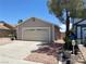Charming single story home showcasing desert landscaping and a two car garage at 1501 Wintergreen Dr, Las Vegas, NV 89128